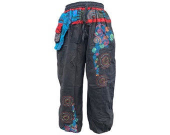 May include: Black pants with colorful embroidered circles and swirls. The pants have a drawstring waist and a loose fit.