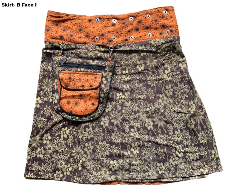 May include: A brown and orange skirt with a floral print. The skirt has a large pocket on the front with a zipper closure. The waistband is orange and has a row of silver eyelets.