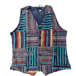 May include: A patchwork vest with a V-neck and button closure. The vest features a variety of colorful striped patterns in shades of blue, red, purple, and yellow. It has two front pockets and a tag near the neckline.