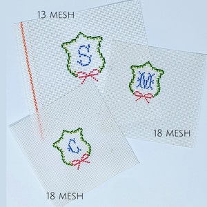May include: Three white canvas panels with green, blue, and red embroidery of a shield with initials. The panels are labeled "13 MESH" and "18 MESH".
