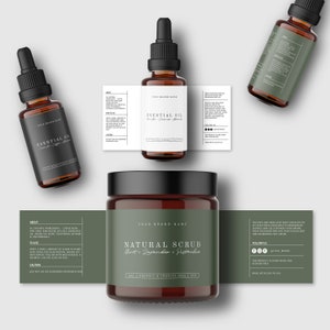 May include: Two amber glass bottles with black lids and labels that read "Essential Oil" and a brown glass jar with a black lid and a green label that reads "Natural Scrub Mint, Lavender, Pistachio". The labels have the text "Your Brand Name" on them.