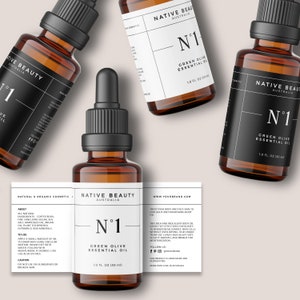 K&ouml;nnte beinhalten: Drei bernsteinfarbene Glasflaschen mit schwarzen Tropfern und Etiketten. Die Etiketten sind wei&szlig; mit schwarzem Text und lauten "Native Beauty Australia" und "N&deg;1 Green Olive Essential Oil" mit der Gr&ouml;&szlig;e "1.0 fl oz (30 ml)".