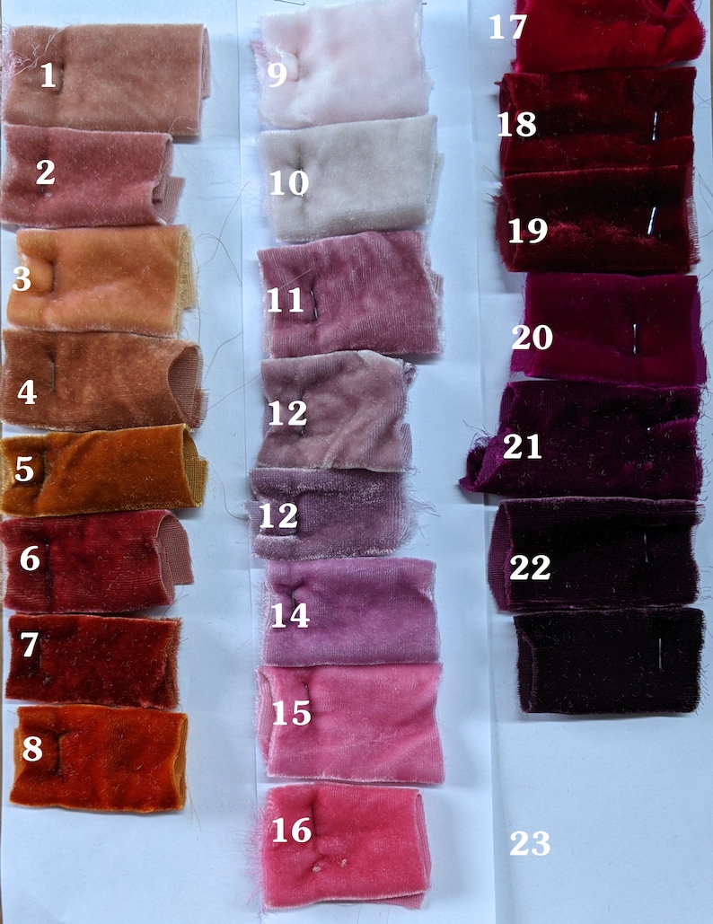 May include: Swatch card with 23 fabric samples in various shades of red, pink, and orange. The samples are numbered 1 through 23.