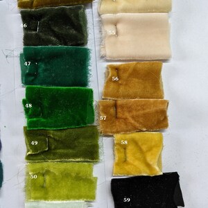 May include: A color chart of fabric swatches, numbered 44 through 59. The swatches are arranged in two columns, with the left column featuring shades of green and the right column featuring shades of yellow, beige, and white. The swatches are all velvet.