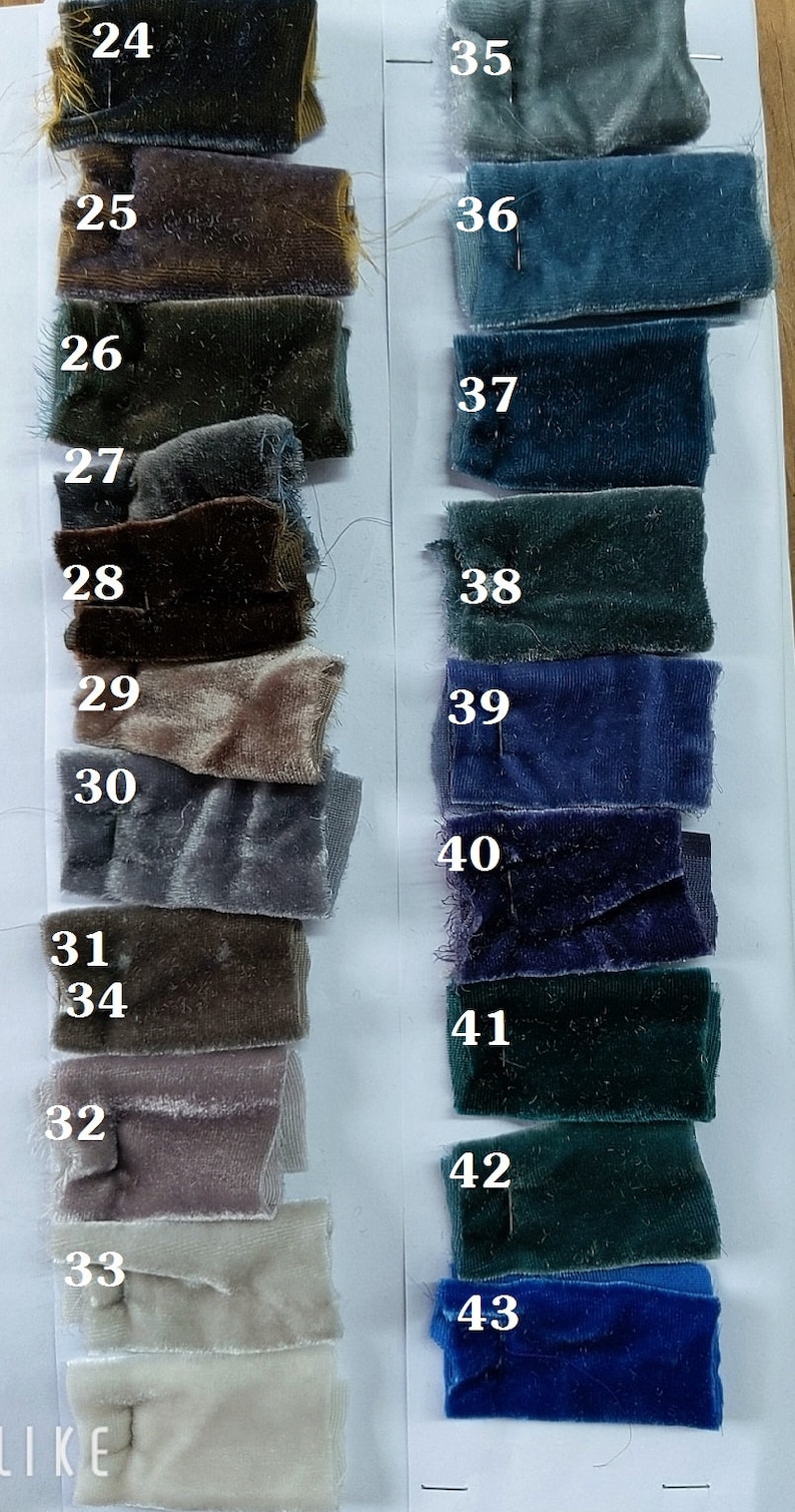 May include: A swatch card displaying 20 fabric samples in a range of blue, green, brown and grey shades. The samples are numbered 24 to 43.