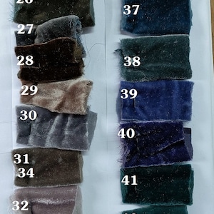 May include: A color chart of fabric swatches, numbered 24 through 43. The swatches are arranged in two columns, with the left column showing shades of brown, gray, and beige, and the right column showing shades of blue and green.