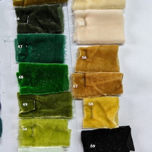 May include: A color chart of fabric swatches, numbered 44 through 59. The swatches are arranged in two columns, with the left column featuring shades of green and the right column featuring shades of yellow, beige, and white. The swatches are all velvet.