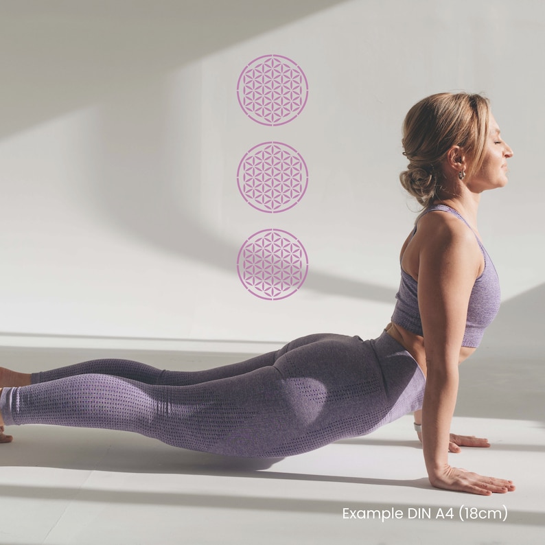 May include: A woman in a purple sports bra and leggings is doing a yoga pose in front of a white wall with three pink flower of life stencils. Example DIN A4 (18cm)