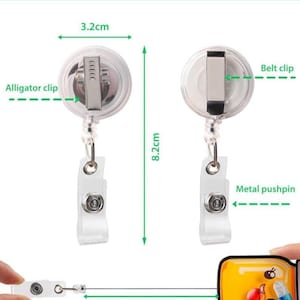 May include: Custom shape acrylic badge reel with an alligator clip and belt clip. The reel measures 3.2 cm in width and 8.2 cm in height, with a 75 cm retractable cord. It features a clear plastic housing and a metal pushpin attachment.
