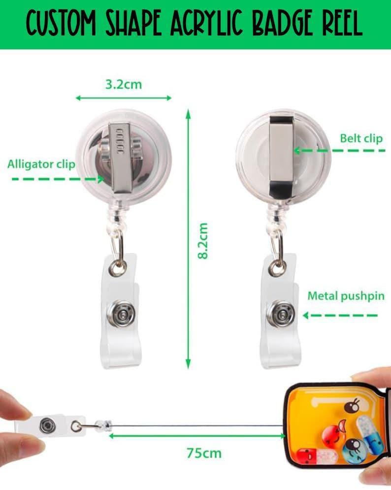 May include: Custom shape acrylic badge reel with an alligator clip and belt clip. The reel measures 3.2 cm in width and 8.2 cm in height, with a 75 cm retractable cord. It features a clear plastic housing and a metal pushpin attachment.