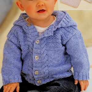 May include: A baby wearing a blue knitted cardigan with a hood and button closure. The cardigan features a cable knit pattern and is shown with a smaller version of the cardigan in a light beige color.