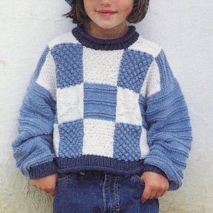 May include: A blue and white checkered knit sweater with a blue denim hat. The sweater has a round neckline and long sleeves.