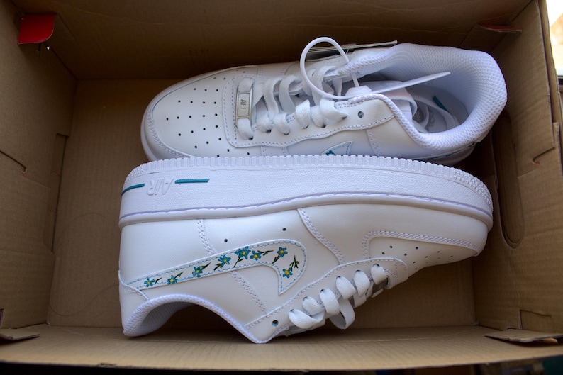 Side view of personalized Nike Air Force 1 shoes with hand-painted blue forget-me-not flowers, ideal for gifting or everyday wear.