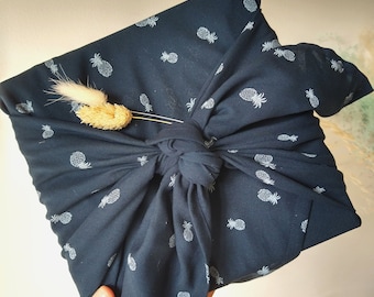 Furoshiki, reusable gift wrapping in blue fabric, pineapple pattern