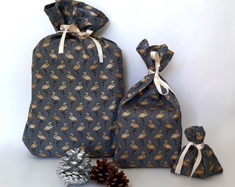 Pouches, reusable gift bags for Christmas, in gray fabric with gold flamingo pattern.
