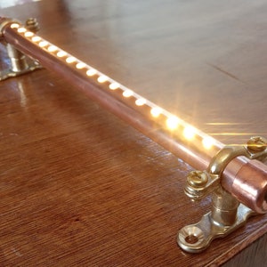 Copper pipe 12V / Mains long led light with switch. Supplied with brass mounting brackets. Campervan, motorhome, boat, reading light.