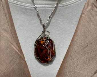 Collana con ciondolo in conchiglia di Paua color ambra rosso-arancio avvolta in filo d'argento sterling