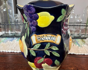 Tarro de cerámica pintado a mano con tapa hermética para galletas Nonni's Biscotti, color azul con frutas.