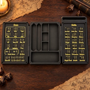 May include: A black, tri-fold tabletop game tracker with yellow text and rotating number dials. The left panel displays stats like STR, DEX, and CON. The right panel lists skills such as Acrobatics and Arcana. The centre section features empty storage compartments.