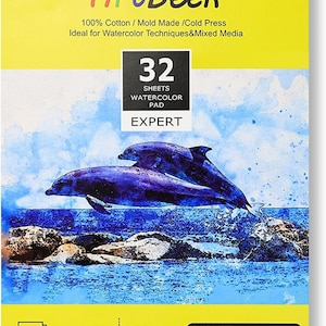 May include: A yellow watercolour pad featuring a dolphin illustration. The pad measures 9 inches by 12 inches and is 140lb (300g/m&sup2;). It is made from 100% cotton and is cold pressed. The pad contains 32 sheets and is labelled "Expert".