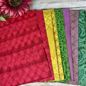 May include: A set of eight patterned paper sheets with a lace design. The sheets are in various colors, including red, yellow, green, purple, and blue.