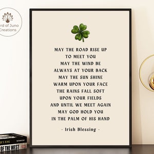 May include: A printable wall art design featuring a green four-leaf clover and black and white text that reads: "May the road rise up to meet you. May the wind be always at your back. May the sun shine warm upon your face. The rains fall soft upon your fields. And until we meet again, may God hold you in the palm of his hand. - Irish Blessing -"