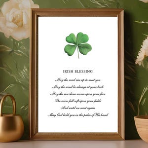 May include: A framed print featuring a green four-leaf clover and an Irish blessing. The blessing reads: "May the road rise up to meet you, May the wind be always at your back, May the sun shine warm upon your face, The rains fall soft upon your fields, And until we meet again, May God hold you in the palm of His hand."