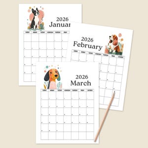 May include: Three 2026 monthly calendars with dog illustrations. January features a black and white dog, February a brown and white dog, and March a dog with orange and black ears. A pencil rests on the bottom right corner.