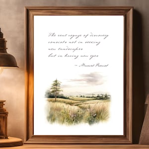 May include: A framed print featuring a watercolour painting of a landscape with a quote by Marcel Proust: "The real voyage of discovery consists not in seeking new landscapes but in having new eyes."