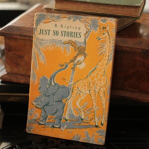 May include: A vintage children's book titled "Just So Stories" by R. Kipling. The cover features a colorful illustration of an elephant, a giraffe, and a monkey in a jungle setting.