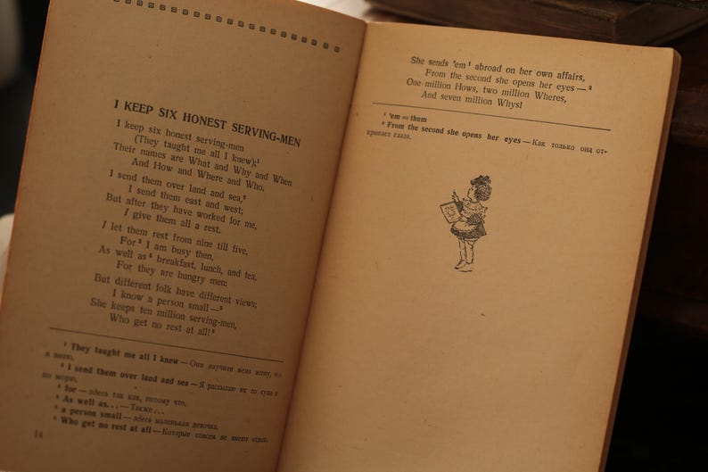 May include: A vintage book with a black and white illustration of a girl holding a book. The text on the page reads "I keep six honest serving-men" and "She sends 'em' abroad on her own affairs, From the second she opens her eyes - One million Hows, two million Wheres, And seven million Why's".
