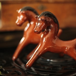 A pair of collectible mid-century porcelain horse figurines