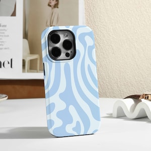 May include: A light blue phone case with a white abstract pattern. The case has a raised camera bump with three lenses.