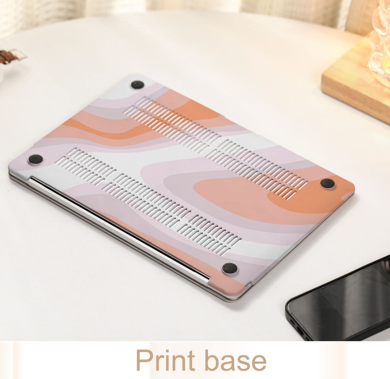 May include: A pink and orange laptop skin with a wavy abstract pattern. The skin is designed to fit a laptop and has a smooth, matte finish.