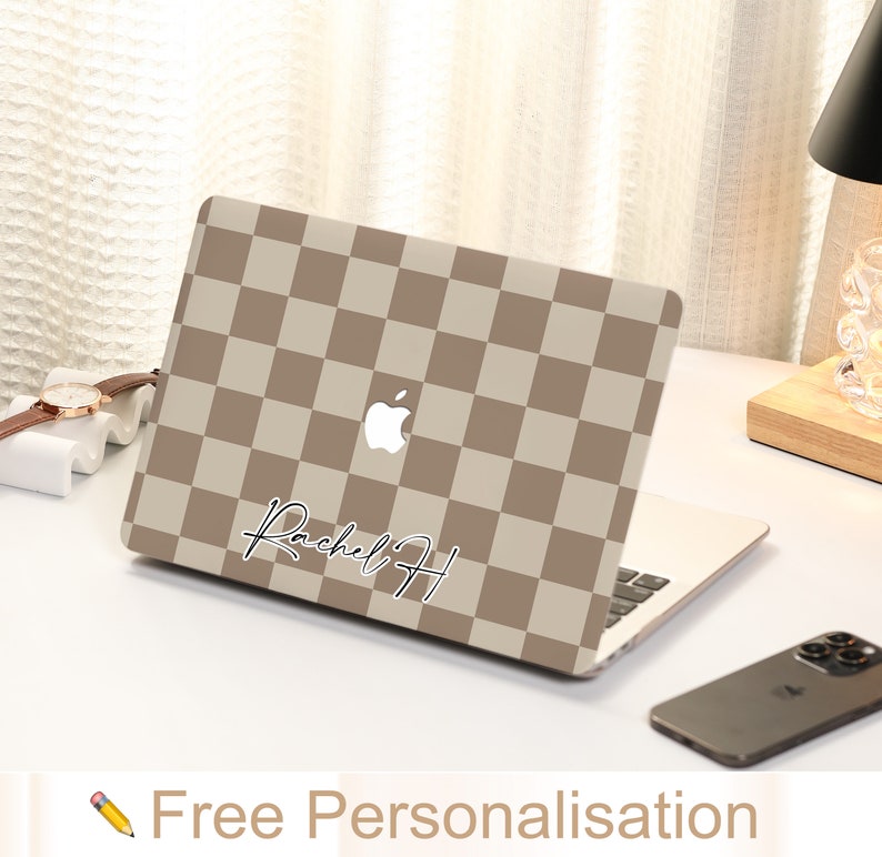 May include: A brown and beige checkered laptop skin with a white Apple logo and the name "Rachel H" written in black cursive.