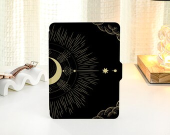 May include: Black and gold e-reader cover with a crescent moon and stars design.