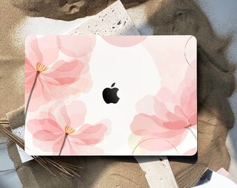 May include: A white laptop computer with a pink floral design. The design features delicate pink flowers with translucent petals and a gold outline. The Apple logo is visible on the laptop.