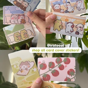 May include: A collection of card cover stickers featuring various cute animal illustrations. Designs include bears, frogs, ducks, and dogs in different settings. The stickers have pastel color schemes and the text "shop all card cover stickers!"