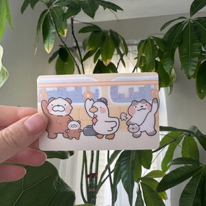 May include: A white ceramic mug with a black handle and the text "But First, Coffee" in a black, handwritten-style font. The mug is on a white surface.