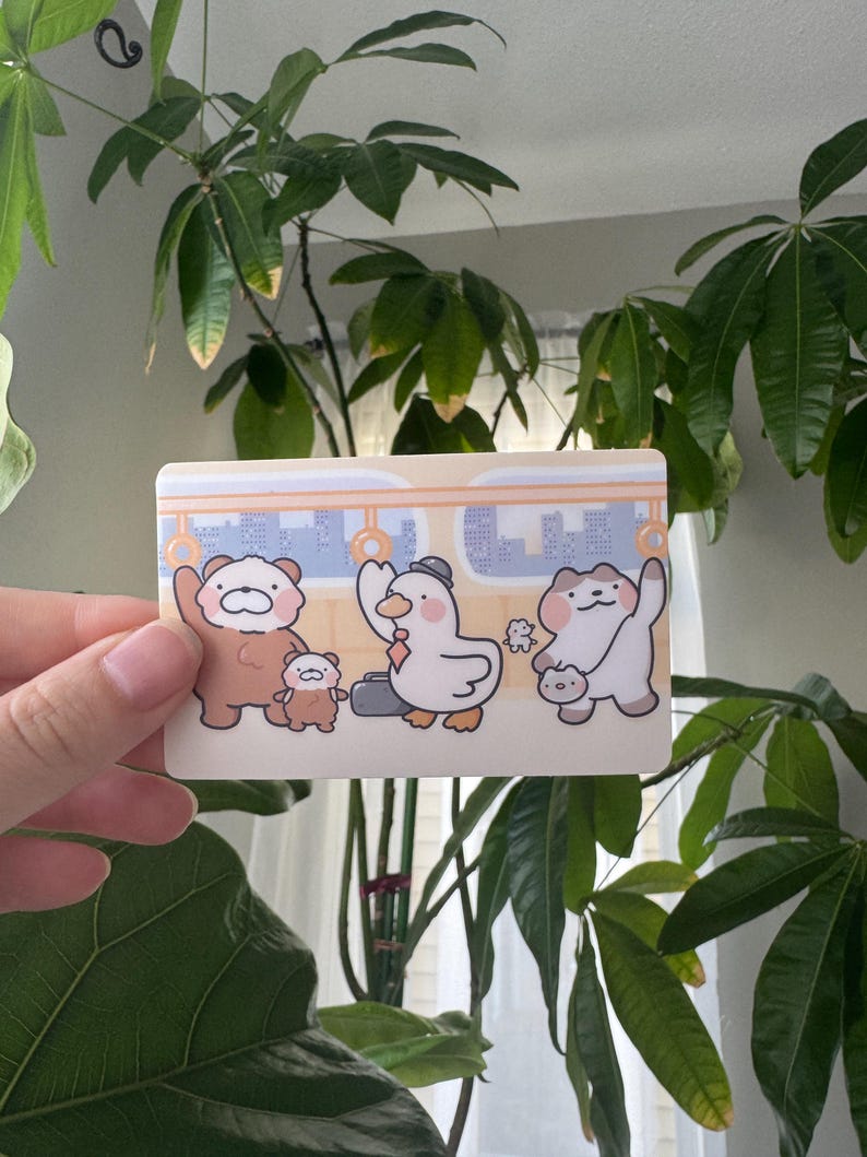 May include: A white ceramic mug with a black handle and the text "But First, Coffee" in a black, handwritten-style font. The mug is on a white surface.