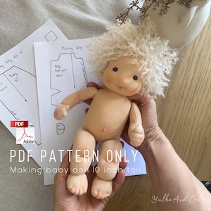 May include: A handmade baby doll with a cream-coloured body and curly blonde hair. The doll is approximately 25 cm tall. The image includes pattern instructions and the text "PDF PATTERN ONLY Making baby doll 10 inch tall."