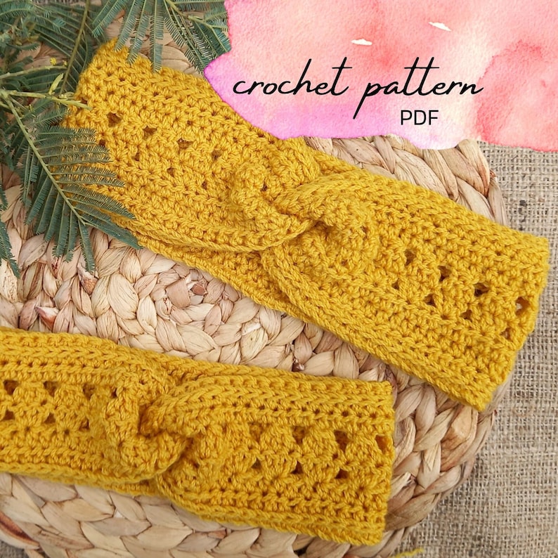 May include: Two mustard yellow crochet headbands with a textured design, lying on a woven mat. The text "crochet pattern PDF" is visible in the upper right corner. The headbands are handmade and appear soft.