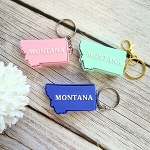 May include: A set of three ceramic mugs with a speckled, matte finish. The mugs are in shades of cream, light gray, and dark gray. Each mug has a simple, minimalist design, perfect for coffee or tea.