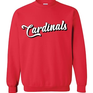 May include: Red sweatshirt with white cursive text that reads "Cardinals".