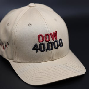 May include: A beige baseball cap with a black and red embroidered logo that says "DOW 40,000".