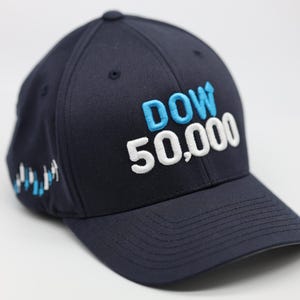 May include: Navy blue baseball cap with the text "DOW 50,000" embroidered in white and light blue. The cap has a curved brim and a small graphic on the side. A classic, sporty accessory.