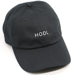May include: A black baseball cap with a white embroidered "HODL" logo.