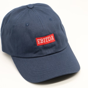 May include: A navy blue baseball cap with a red patch that says "EBITDA" in white lettering.