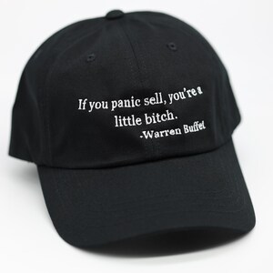 May include: Black baseball cap with a curved brim. The cap features white embroidered text that reads, "If you panic sell, you're a little bitch. -Warren Buffet."