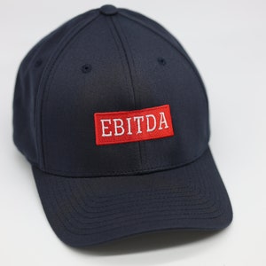 May include: A navy blue baseball cap with a red patch that says "EBITDA" in white lettering.